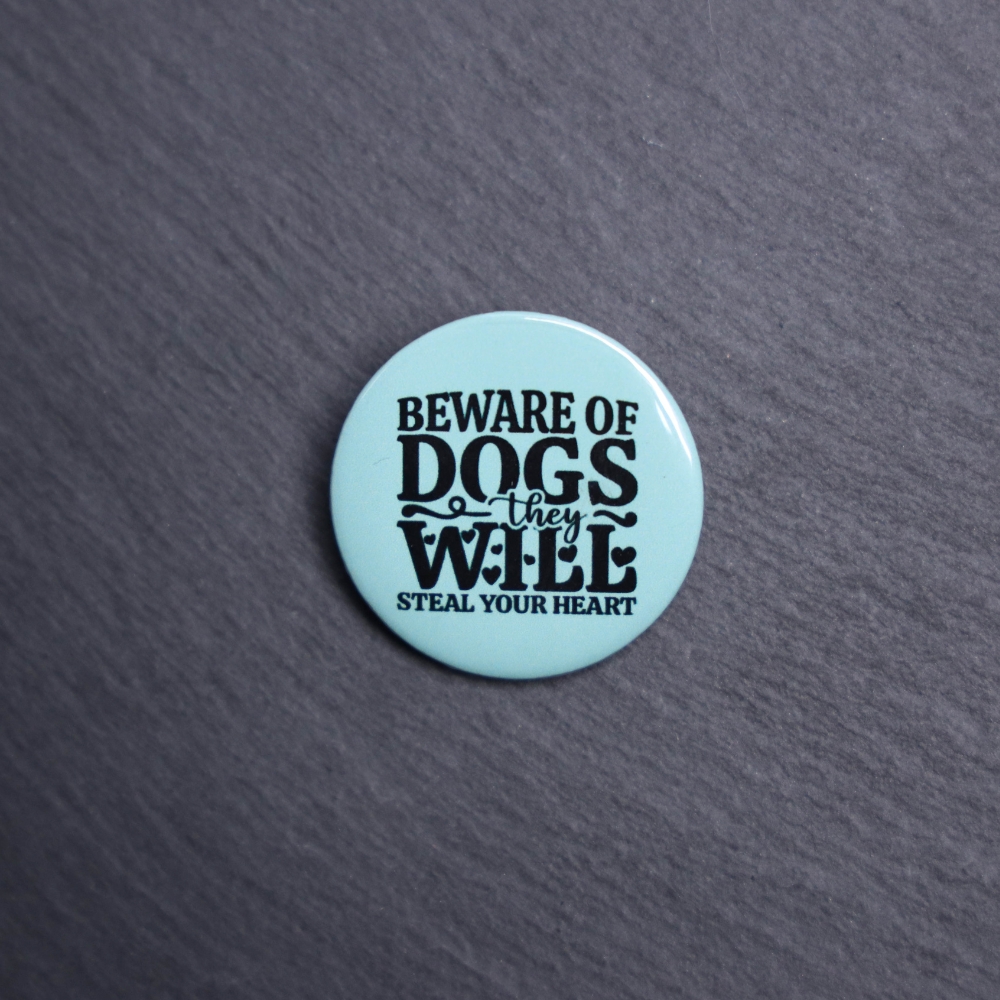 Beware Of Dogs They Will Steal Your Heart Button. These buttons are made with photo paper, metal round, and metal backing. These buttons are vibrant and fun to use on bags or vests.