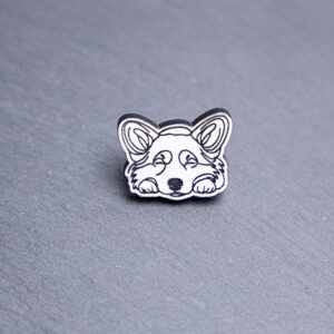 Corgi Engraved Acrylic Pin. These acrylic pins are made with engraved cast acrylic. These pins are white and black with a black pin back.