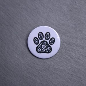 Floral Paw Gray Button. These buttons are made with photo paper, metal round, and metal backing. These buttons are vibrant and fun to use on bags or vests.
