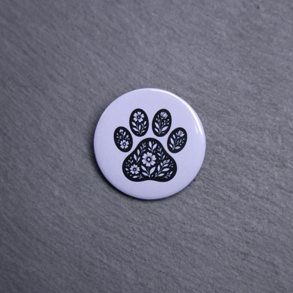 Floral Paw Gray Button. These buttons are made with photo paper, metal round, and metal backing. These buttons are vibrant and fun to use on bags or vests.