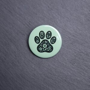 Floral Paw Green Button. These buttons are made with photo paper, metal round, and metal backing. These buttons are vibrant and fun to use on bags or vests.