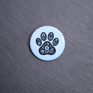 Floral Paw Light Blue Button. These buttons are made with photo paper, metal round, and metal backing. These buttons are vibrant and fun to use on bags or vests.