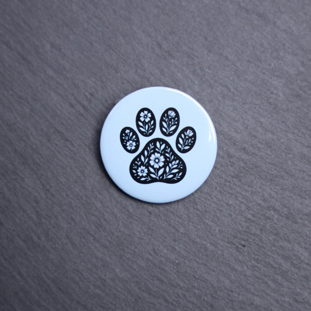 Floral Paw Light Blue Button. These buttons are made with photo paper, metal round, and metal backing. These buttons are vibrant and fun to use on bags or vests.