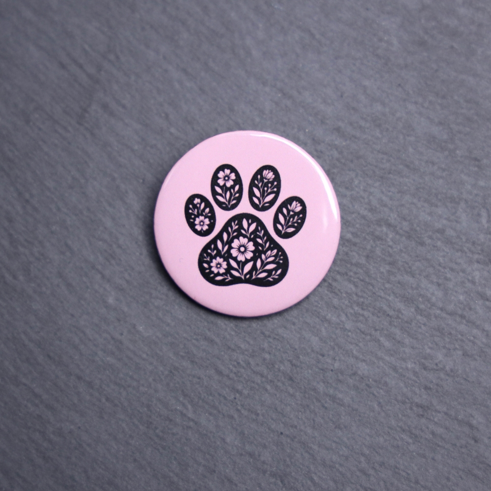 Floral Paw Pink Button. These buttons are made with photo paper, metal round, and metal backing. These buttons are vibrant and fun to use on bags or vests.