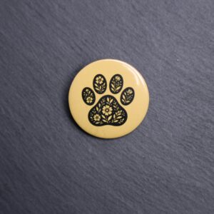 Floral Paw Yellow Button. These buttons are made with photo paper, metal round, and metal backing. These buttons are vibrant and fun to use on bags or vests.