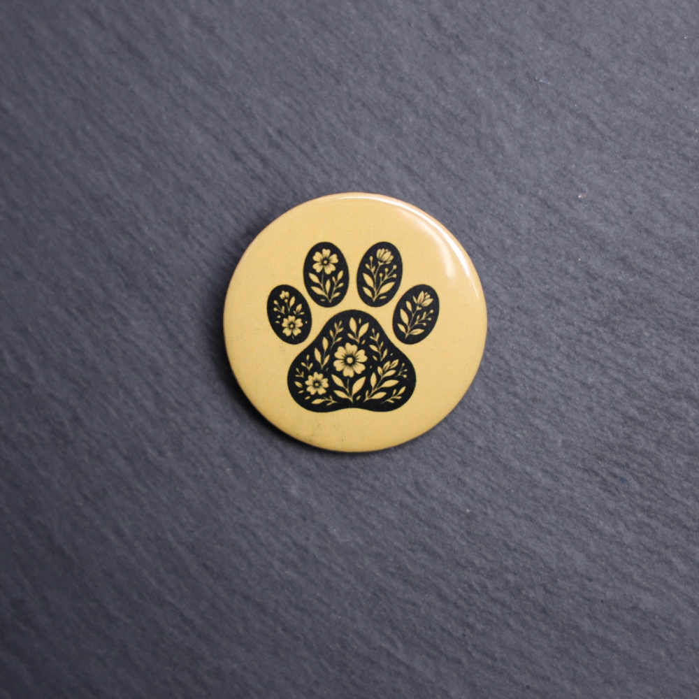 Floral Paw Yellow Button. These buttons are made with photo paper, metal round, and metal backing. These buttons are vibrant and fun to use on bags or vests.