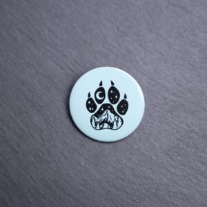 Forest Paw Light Blue Button. These buttons are made with photo paper, metal round, and metal backing. These buttons are vibrant and fun to use on bags or vests.