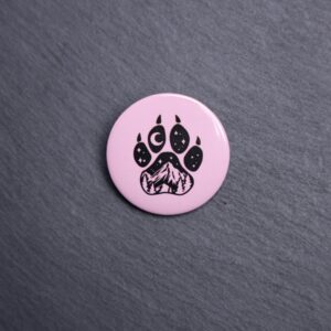 Forest Paw Pink Button. These buttons are made with photo paper, metal round, and metal backing. These buttons are vibrant and fun to use on bags or vests.