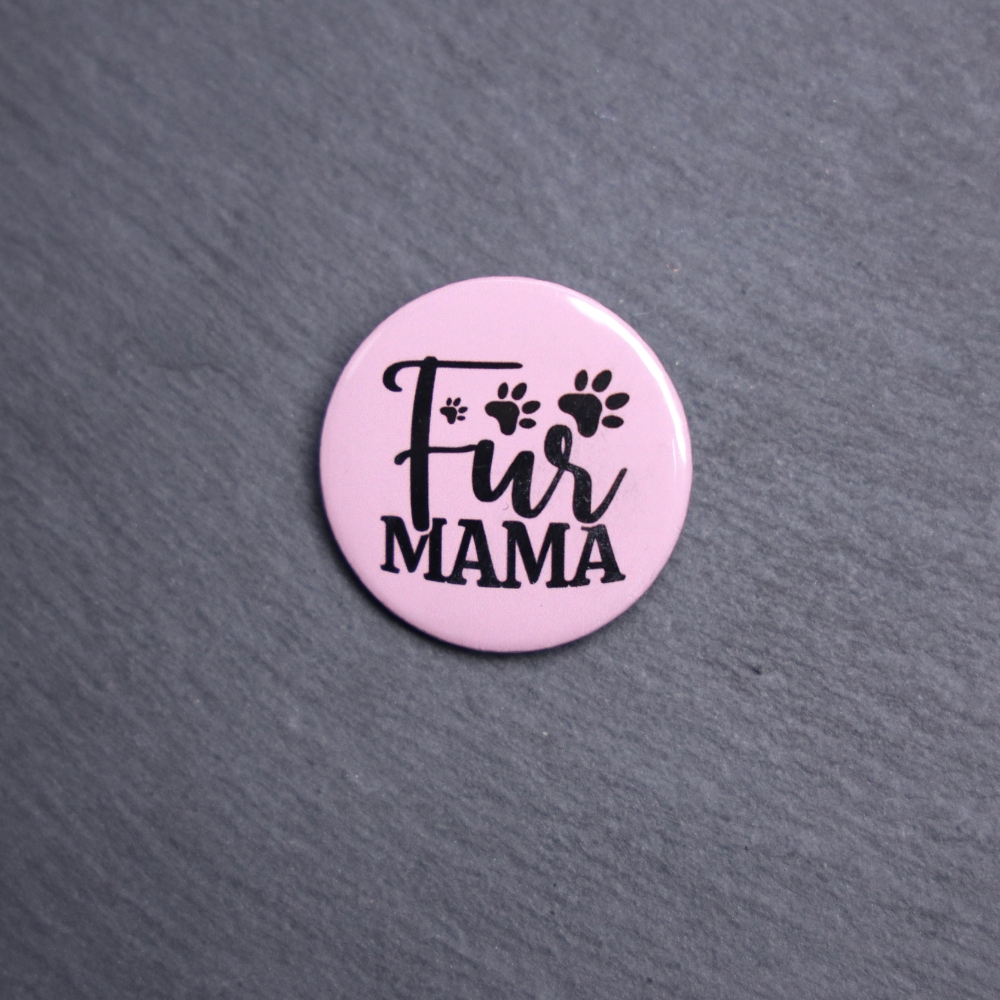 Fur Mama Button. These buttons are made with photo paper, metal round, and metal backing. These buttons are vibrant and fun to use on bags or vests.