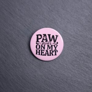Paw Prints On My Heart Button. These buttons are made with photo paper, metal round, and metal backing. These buttons are vibrant and fun to use on bags or vests.