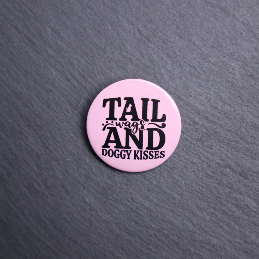 Tail Wags And Dog Kisses Button. These buttons are made with photo paper, metal round, and metal backing. These buttons are vibrant and fun to use on bags or vests.