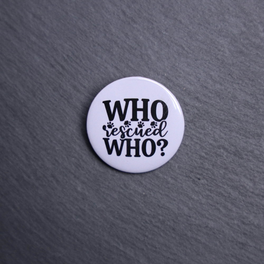 Who Rescued Who Button. These buttons are made with photo paper, metal round, and metal backing. These buttons are vibrant and fun to use on bags or vests.