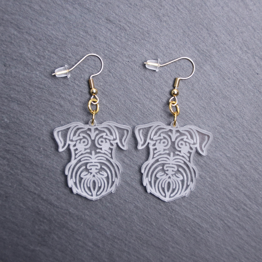 Mini Schnauzer Earrings. These earrings are made with engraved acrylic. Comes with gold hooks that is nickel free. Adorable dangle earrings for dog lovers.